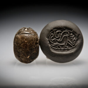 A Hyksos Steatite Scarab Engraved with a Sphinx with a Cobra above it, and a Palm Branch in Front