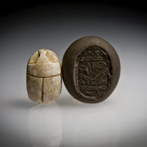 A Hyksos Steatite Scarab Engraved with Horus Falcon Wearing Red Crown and Hieroglyphs