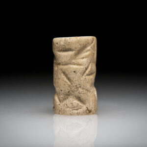 An Early-Dynastic Limestone Cylinder Seal with a Seated Figure, a Bird and an Animal