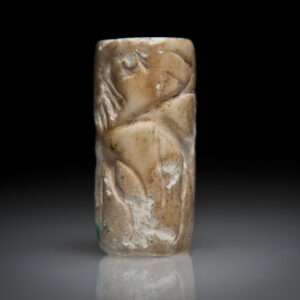 An Akkadian Plagioclase Cylinder Seal with Two Lions, and a Figure Feeding a Gazelle